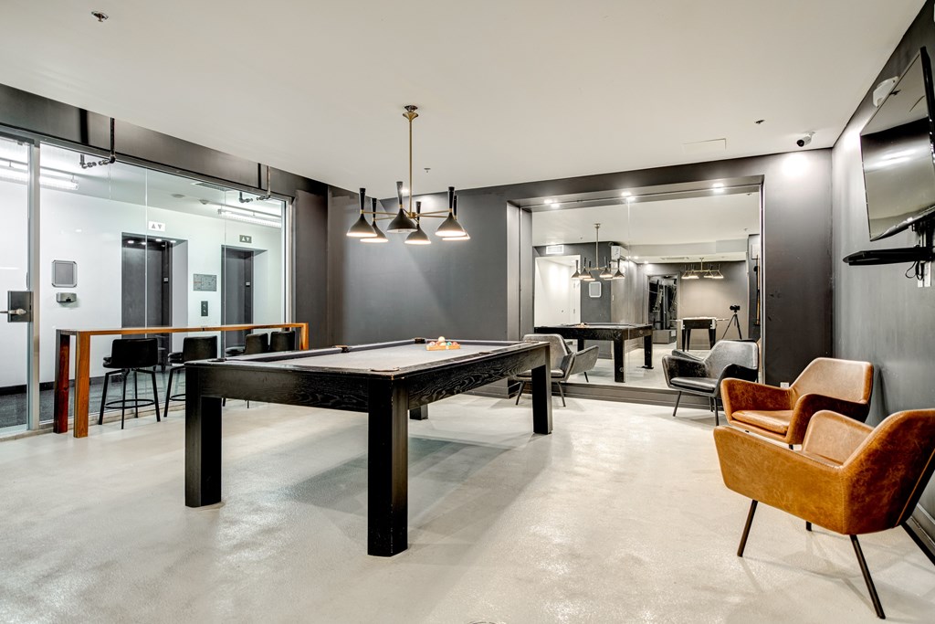 a game room with a pool table and a bar