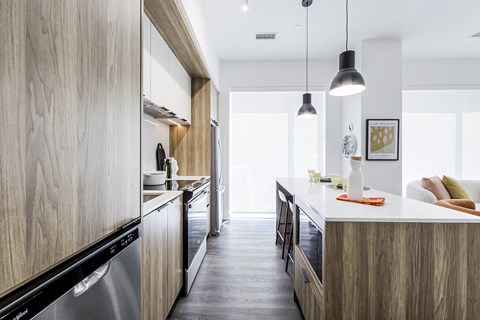 a kitchen with wooden cabinets and a white counter top