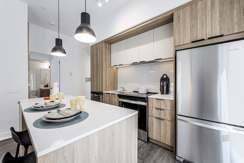 A modern kitchen with a dining table and chairs.