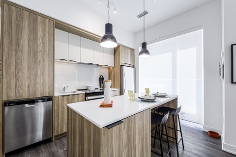 a kitchen with a large island with a white counter top