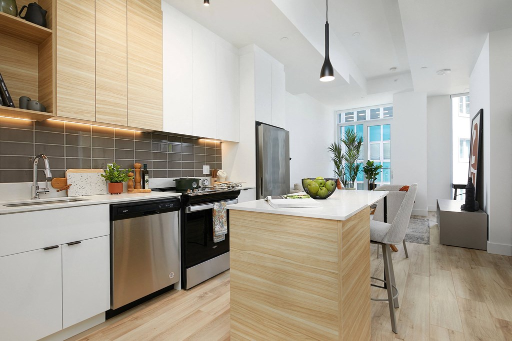 A modern kitchen with wooden cabinets and a central island.