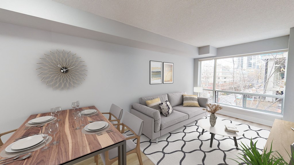 our living room and dining room with a large window and a wooden table