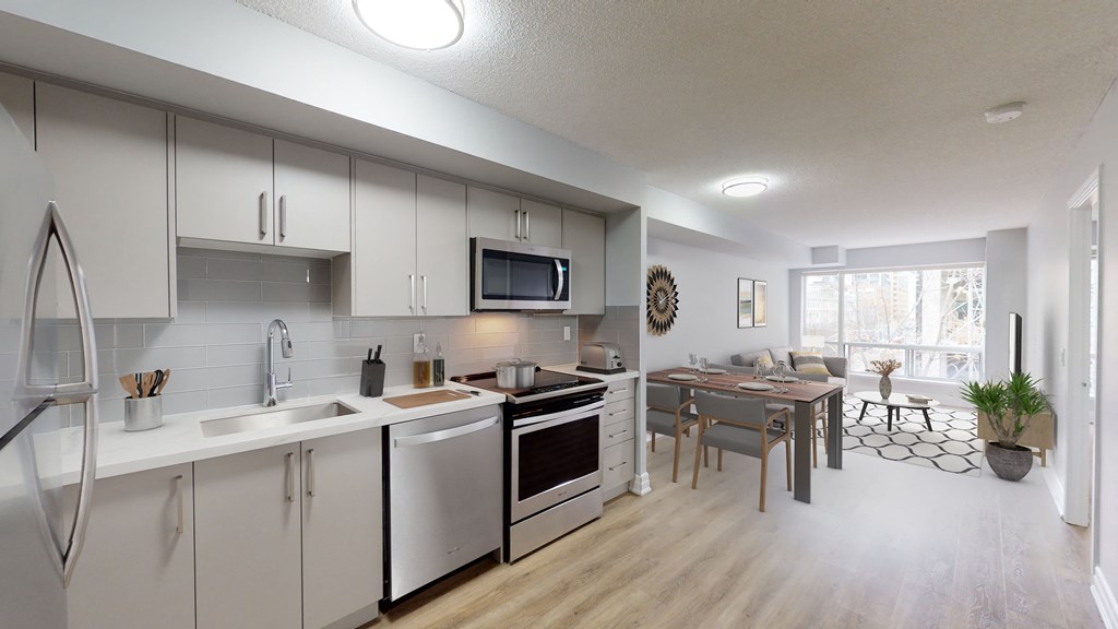 an open kitchen and living room with a dining room table