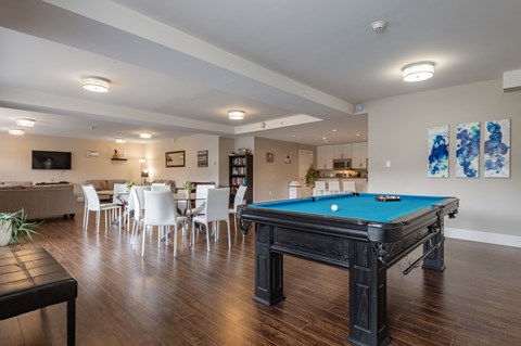 a game room with a pool table and a bar