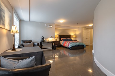 a bedroom with a bed and a table and chairs