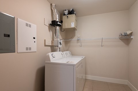 a utility room with a washer and dryer and a dryer in it