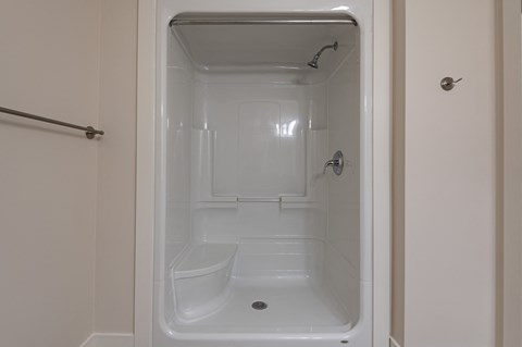 a small shower in a bathroom with a shower curtain