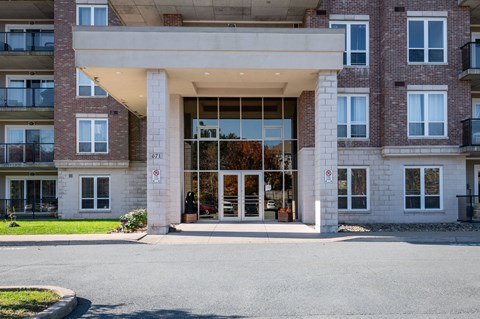 the entrance to a large brick building with glass doors