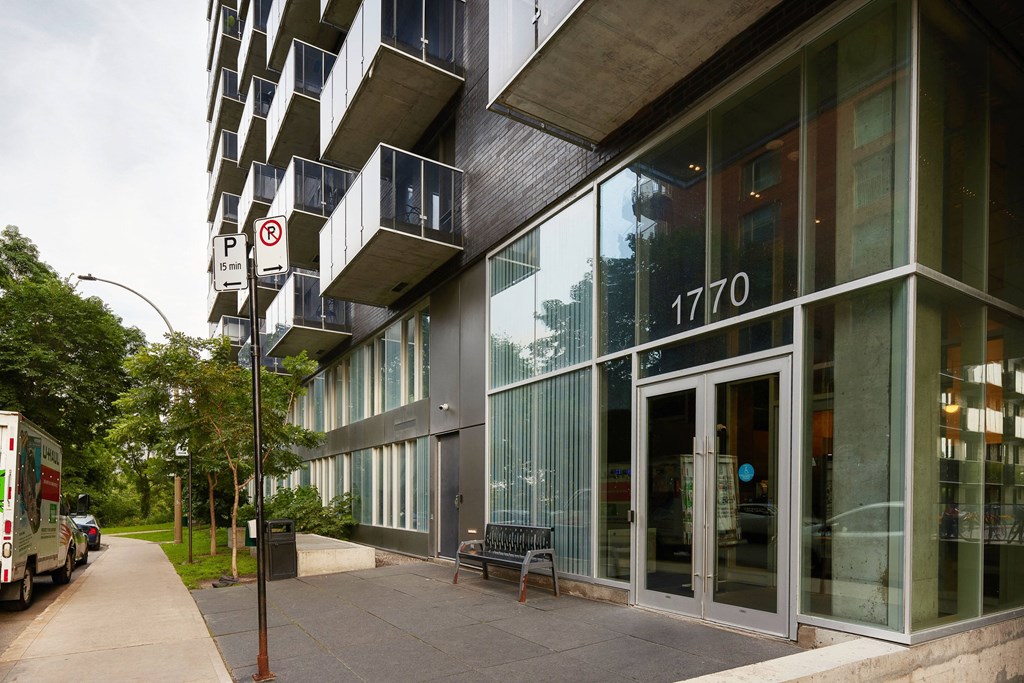 the side of a building with a bus parked outside of it