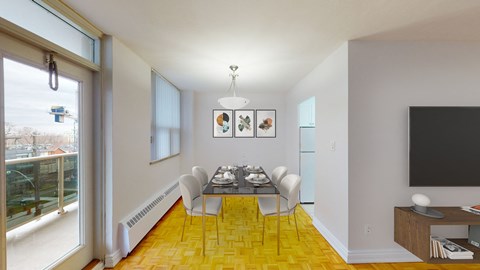 A dining room with a table set for four.