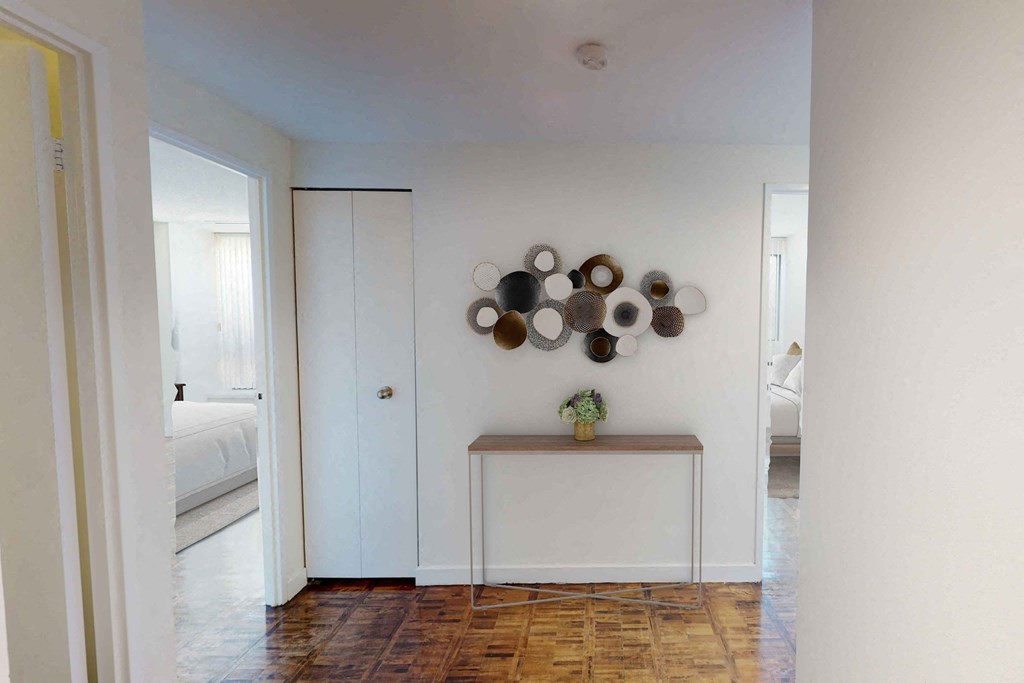 a bedroom with a medium sized bed and a doorway leading to a bathroom