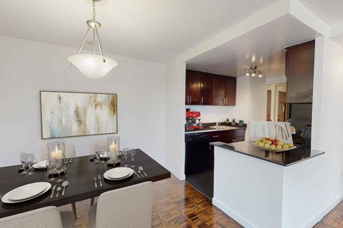 a dining room and kitchen with a table and chairs