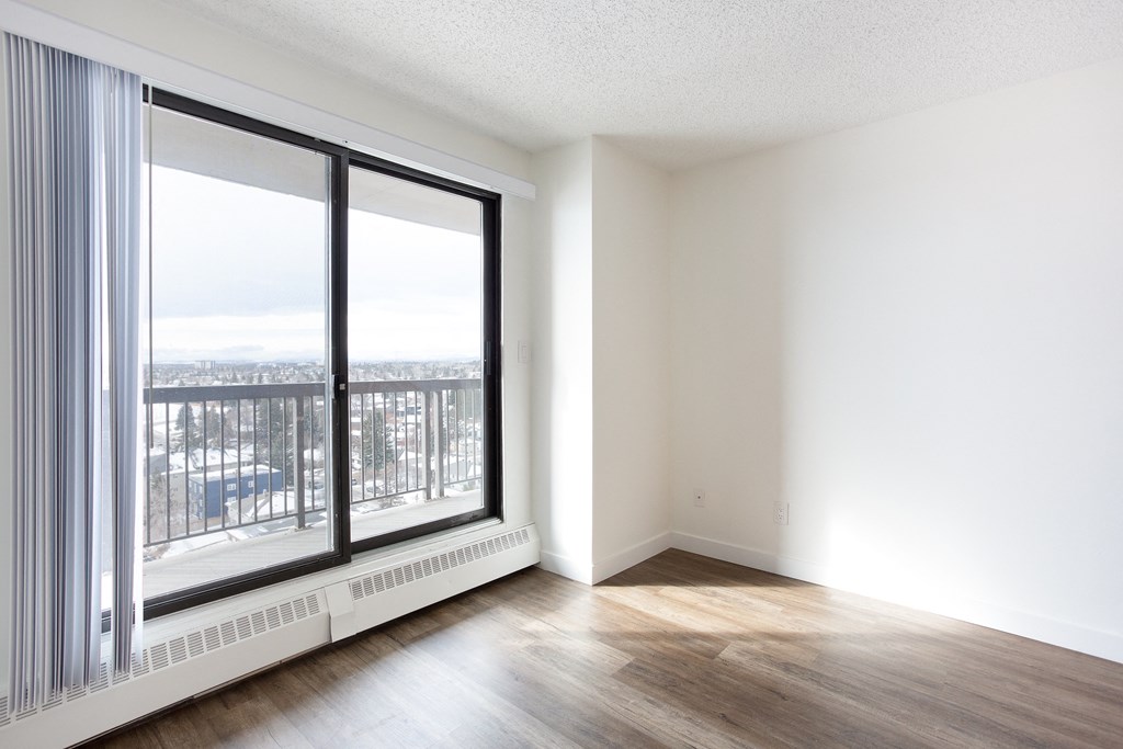A room with a large window overlooking a balcony.