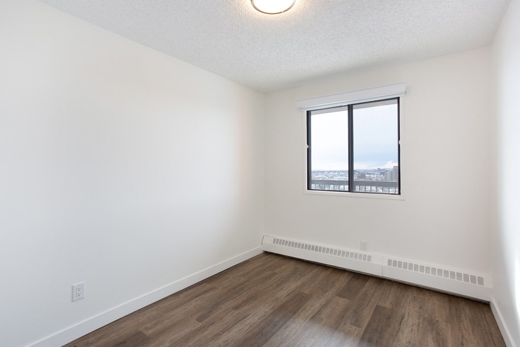 A room with a window and a view of the outside.