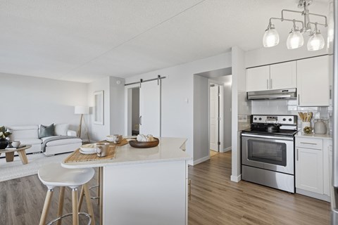A modern kitchen with a breakfast bar and a stove top oven.