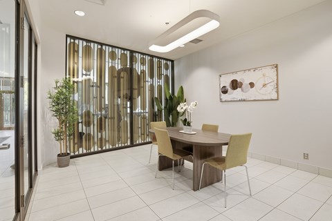 A dining room with a table and chairs.