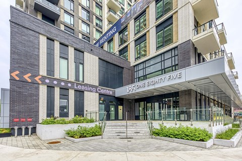 The front of a building with a leasing center entrance.