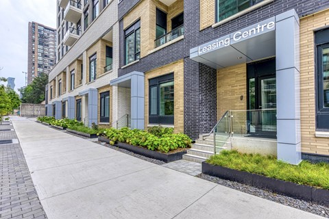 A Leasing Centre building with a brick facade and a glass entrance.
