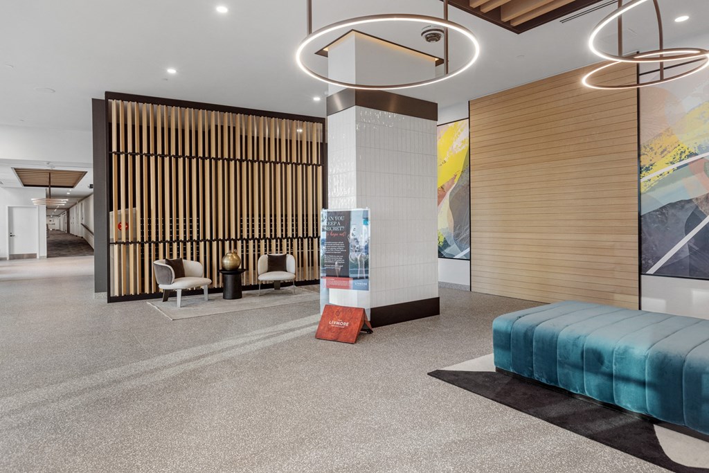 the lobby of a hotel with a bed and a sign