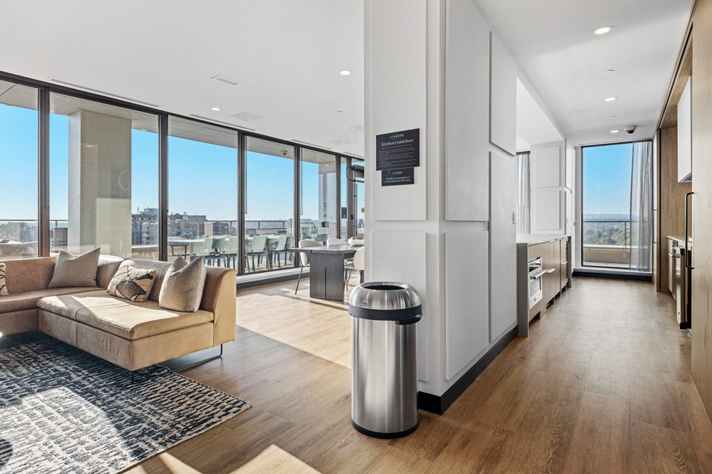 a living room with a couch and a view of the city from the window