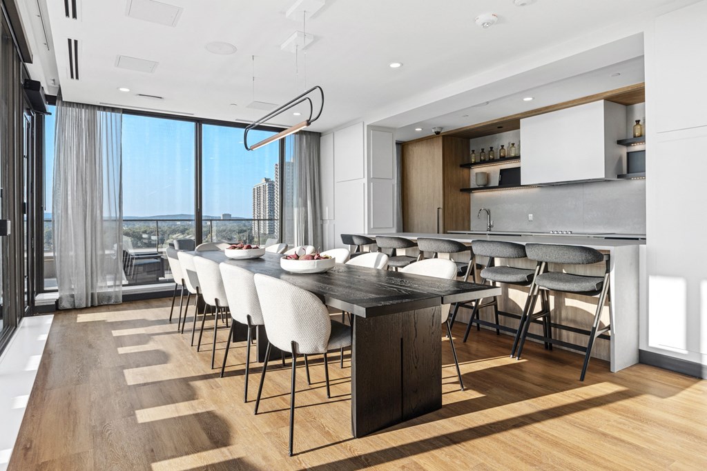 a kitchen with a large island and a table with chairs