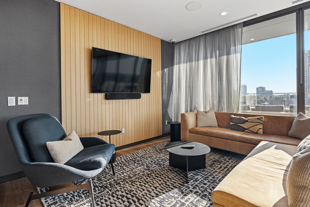 a living room with a couch and a chair and a television