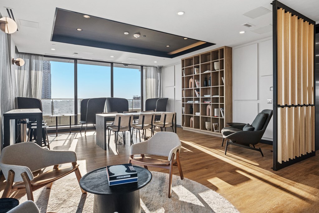 a living room with a table and chairs and a large window