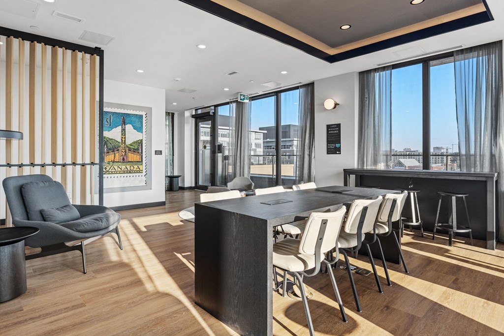 a conference room with a long table and chairs and a large window
