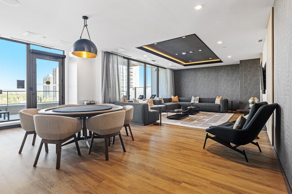 a living room with a table and chairs and a large window