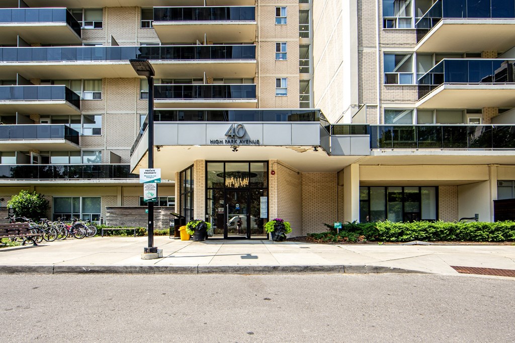 A modern apartment building with a bicycle parked in front.