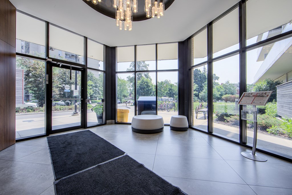 A modern room with a black carpet and a chandelier.