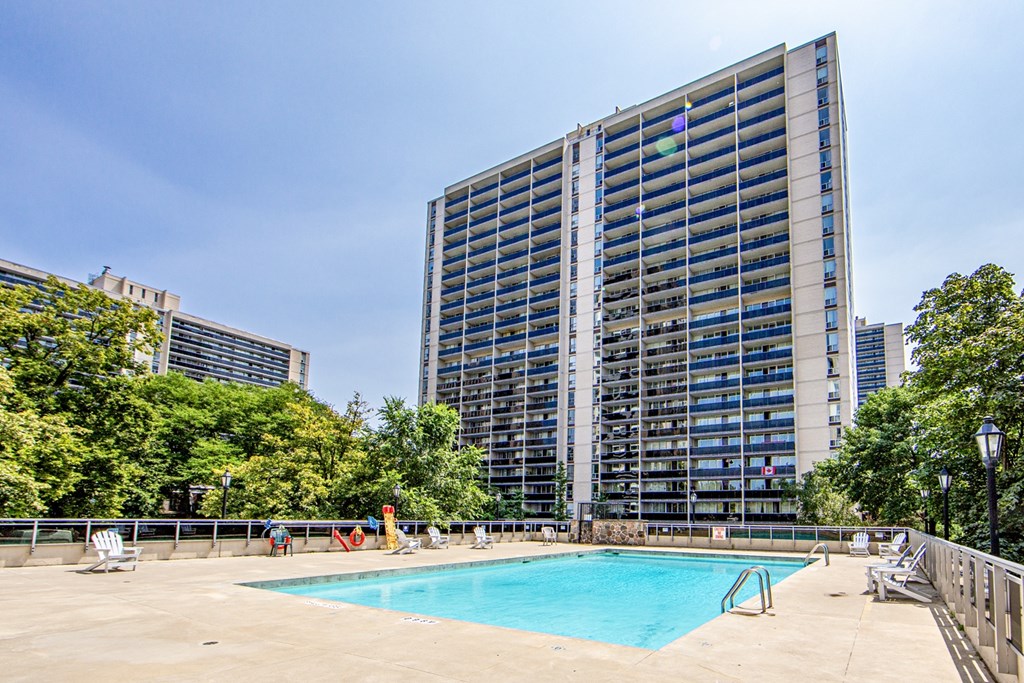 A large building with a pool in front of it.