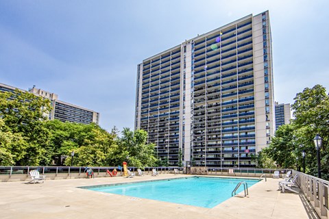 A large building with a pool in front of it.