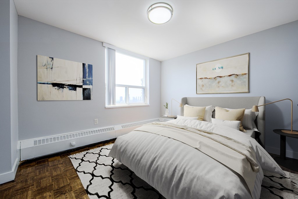A bedroom with a large bed and two pieces of artwork on the wall.