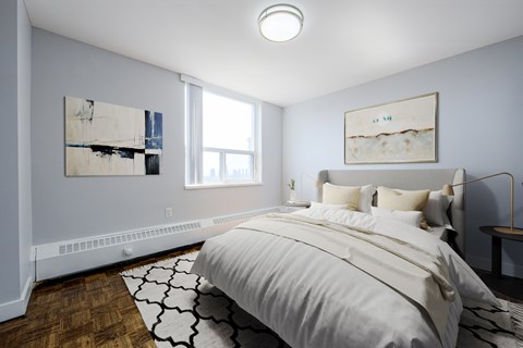 A bedroom with a large bed and two pieces of artwork on the wall.
