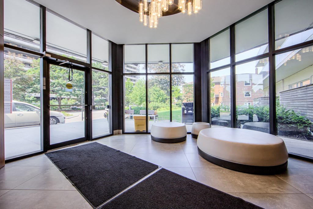 A modern room with a black carpet and a chandelier.