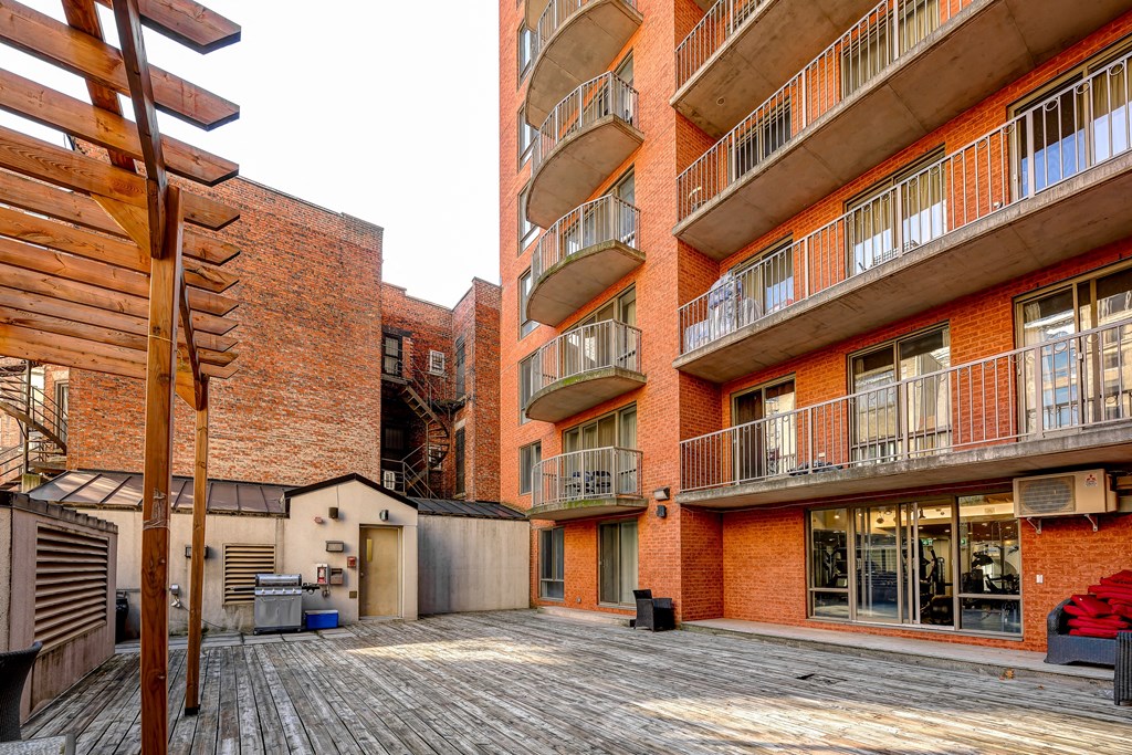 A red brick building with a wooden balcony.