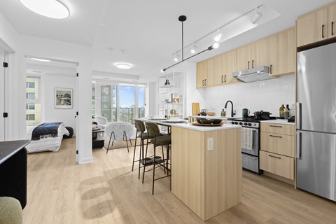 A modern kitchen with wooden cabinets and stainless steel appliances.