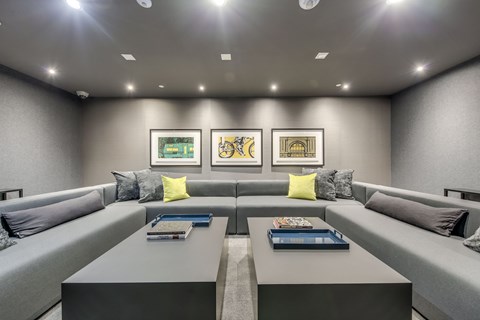 A modern living room with grey couches and a coffee table.