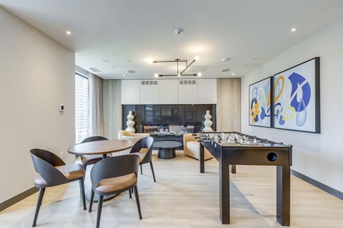 A modern dining room with a pool table and a fireplace.