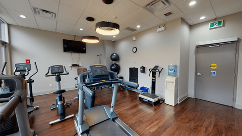 Gym Room - 50 Prince Arthur a gym with treadmills and other exercise equipment in a room with a tv at 50 Prince Arthur