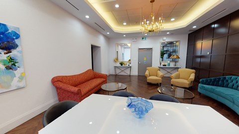 a living room with couches and chairs and a table