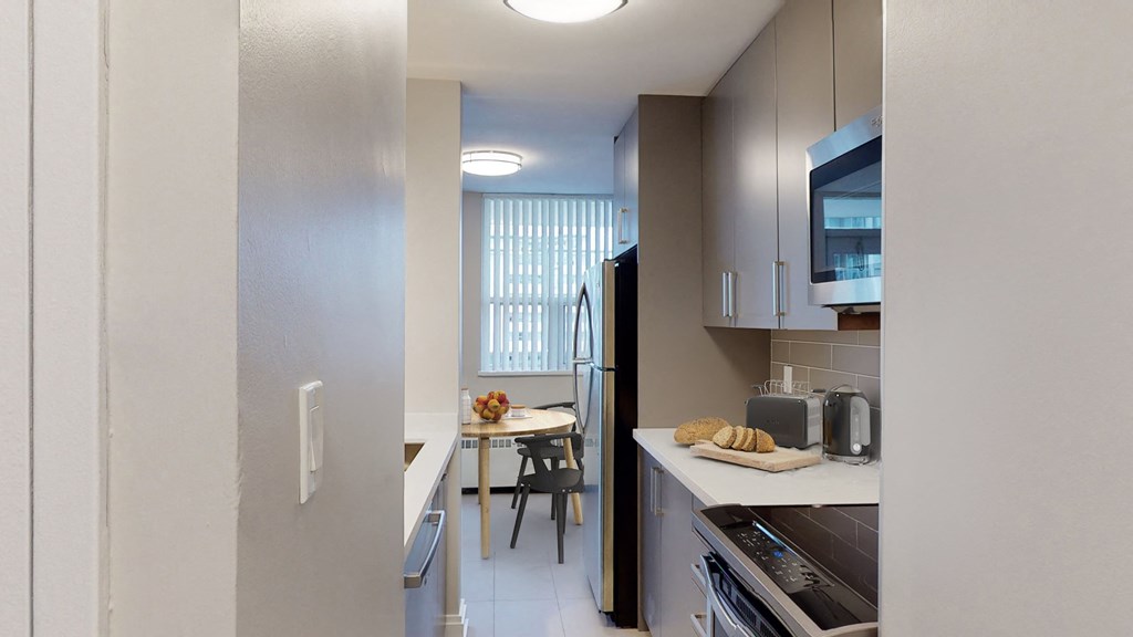 Kitchen with fridge, oven, microwave, and counter space