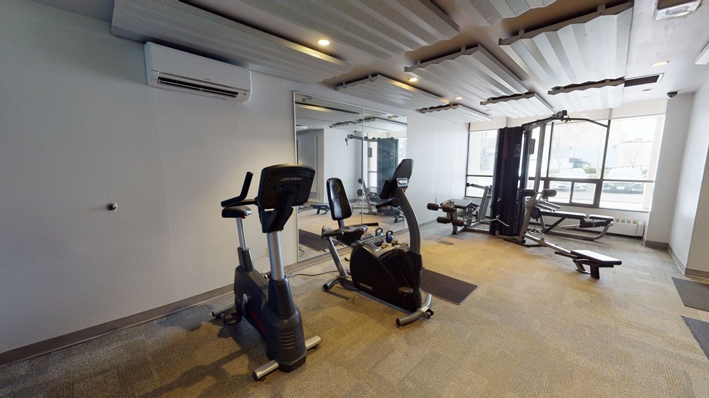 a workout room with exercise equipment in a building