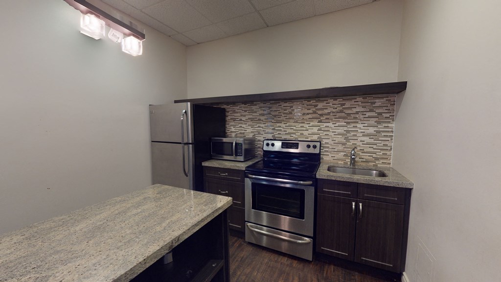 Social Room Kitchen, with oven, microwave, and fridge