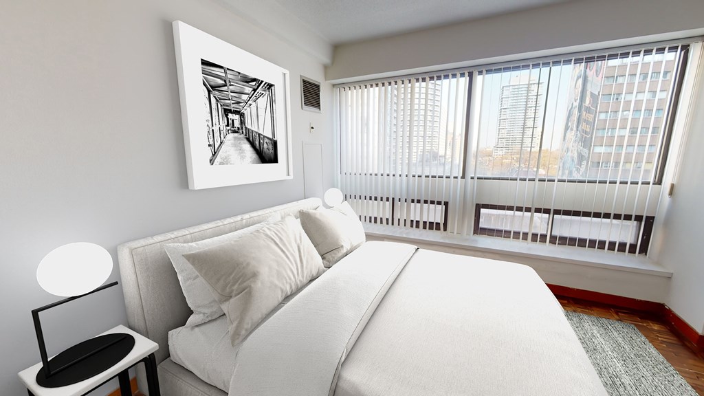 a bedroom with a large bed and a large window