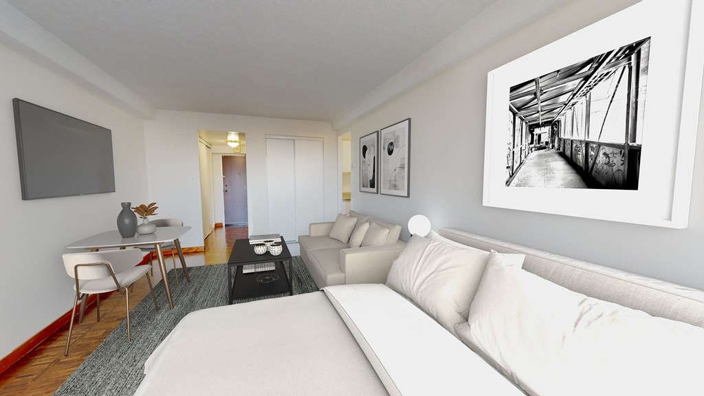 a living room with a large white couch and a tv