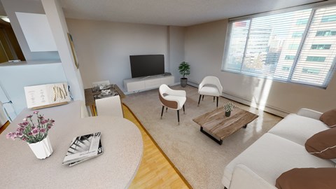 a living room with a couch and chairs and a tv