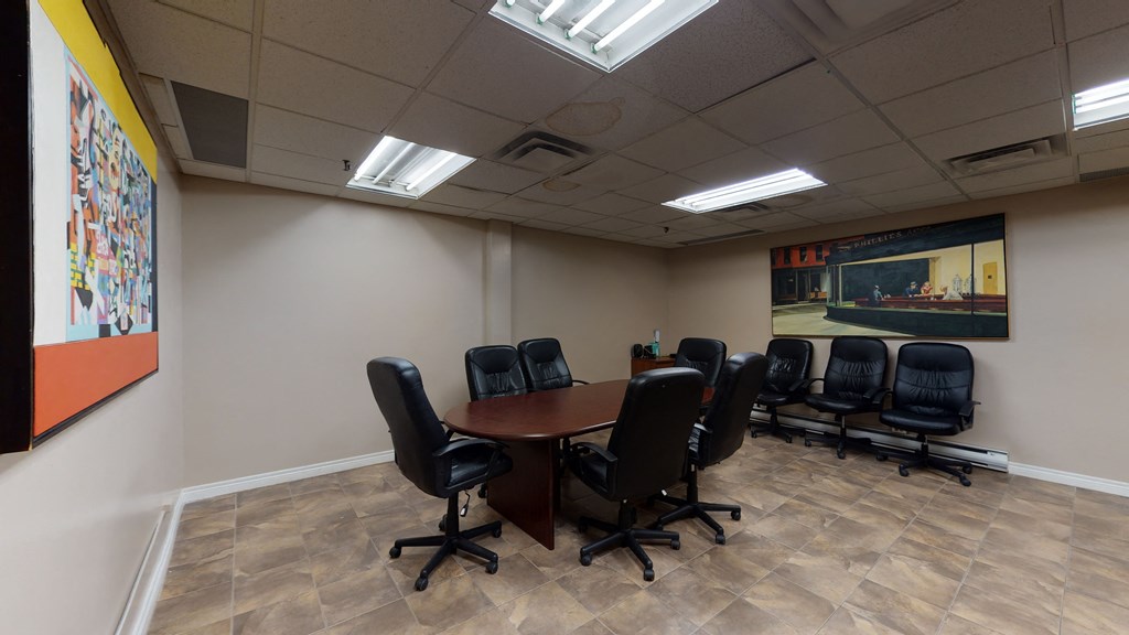 a conference room with a wooden table and chairs