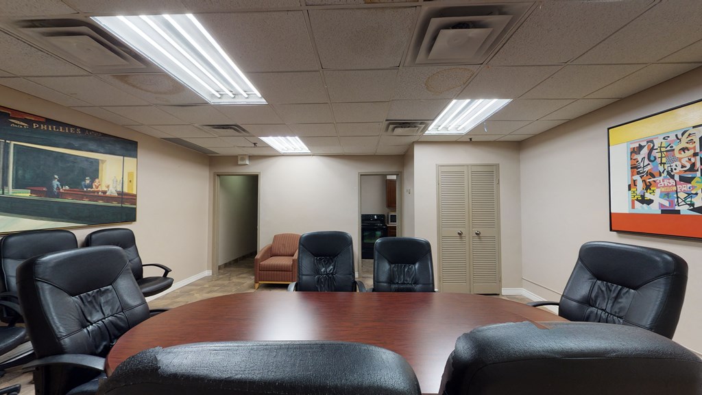 a conference room with a table and chairs